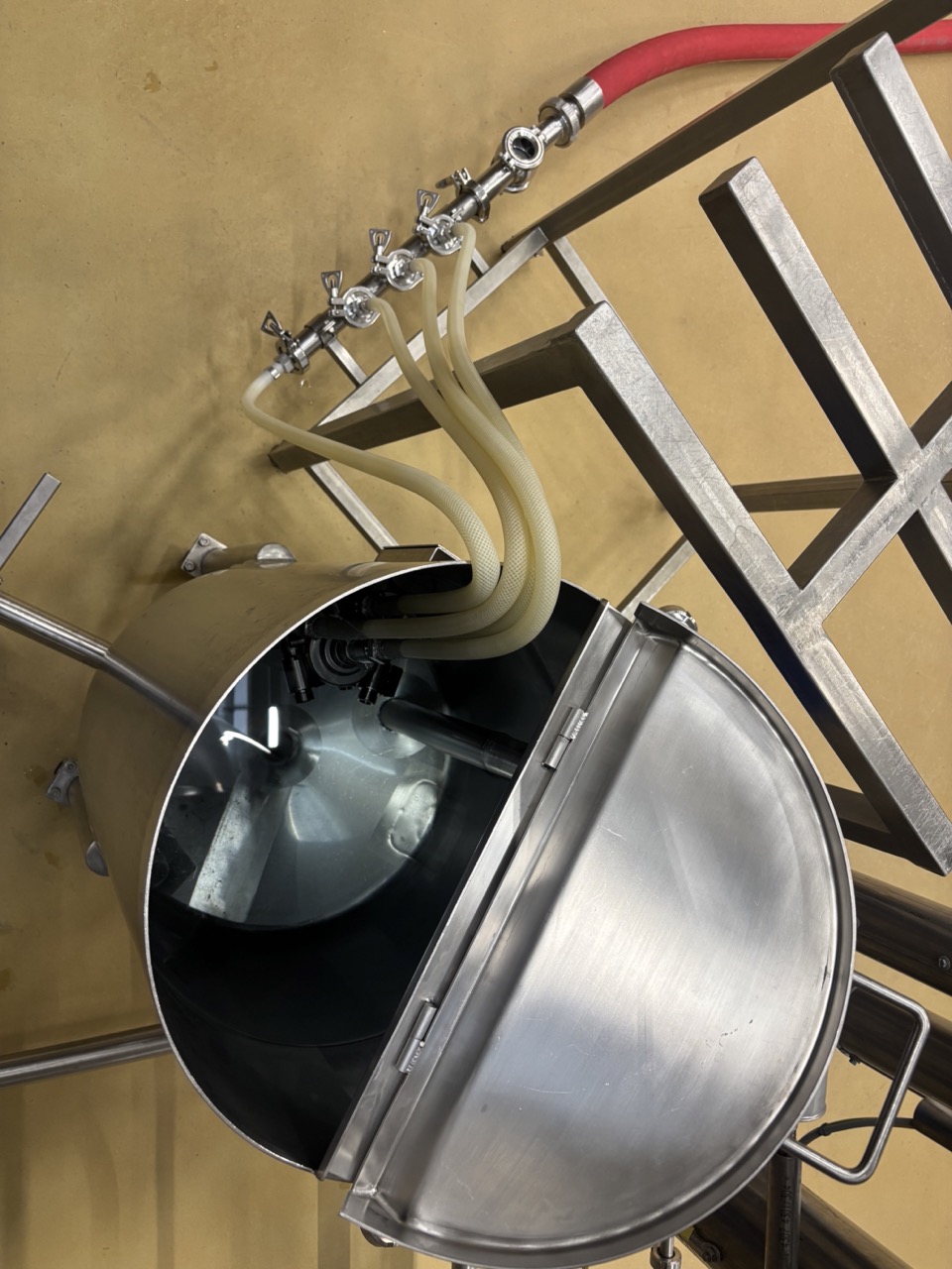 Couplers and filling lines hanging inside the dosing tank — coupler handles removed and set aside