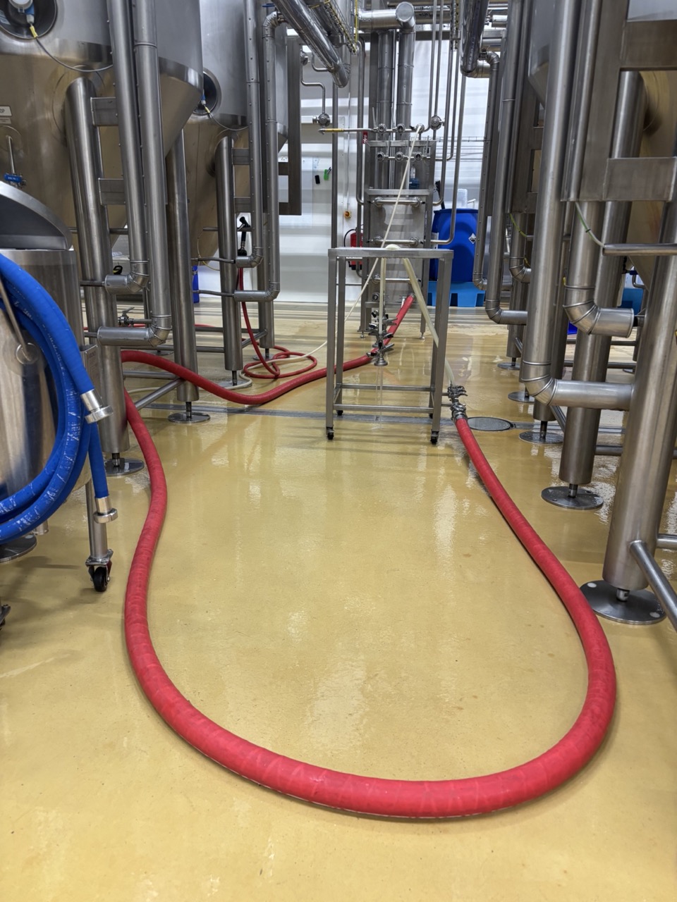 Rinsing the kegger line with water at the panel connection